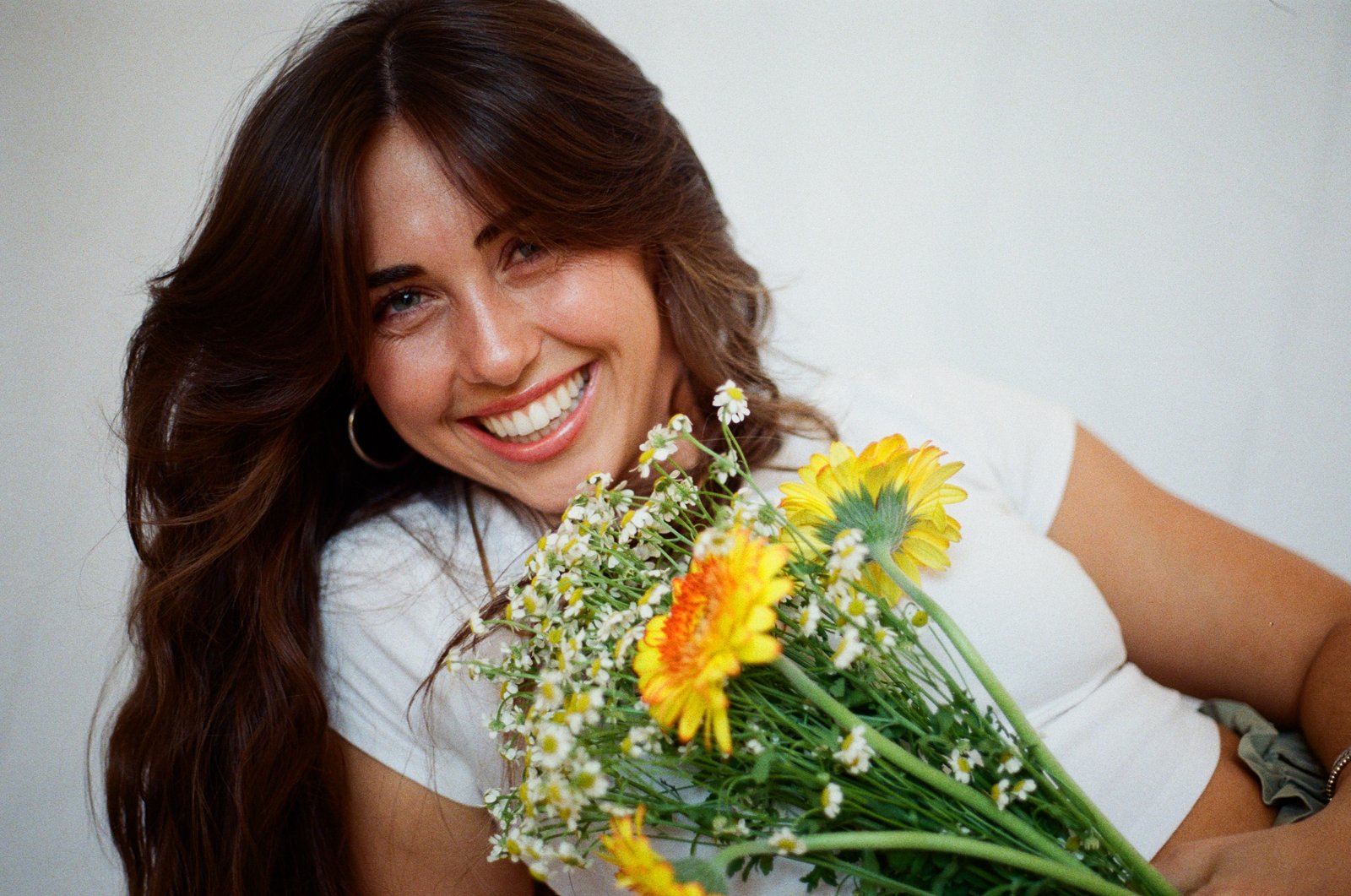 35mm film portrait of Erin Hart smiling with flowers