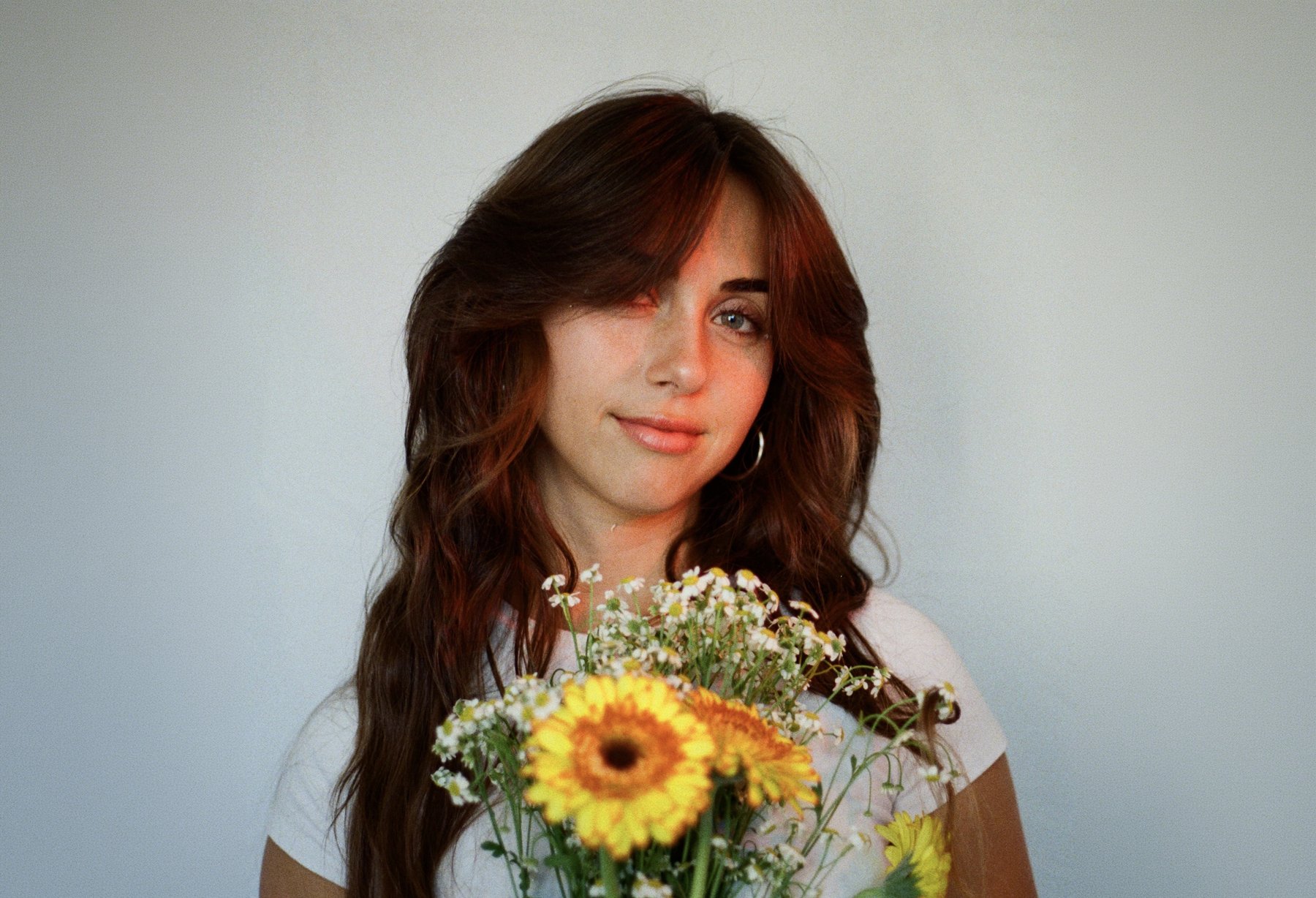 35mm film portrait of Erin Hart holding a bouquet of flowers